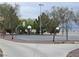 Community basketball court surrounded by trees and accessible by paved walking paths at 700 Carnegie St # 2013, Henderson, NV 89052