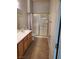 Bathroom featuring wood cabinets, granite countertops, shower, tile flooring, and neutral paint at 700 Carnegie St # 2013, Henderson, NV 89052