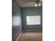 Bedroom with gray walls, neutral carpeting, ceiling fan, and large window with natural light at 700 Carnegie St # 2013, Henderson, NV 89052