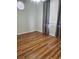 Bedroom with wood flooring, ceiling fan, and window with dark gray curtains at 700 Carnegie St # 2013, Henderson, NV 89052