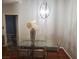 Contemporary dining room with a glass-top table, modern chandelier, and seating for four at 700 Carnegie St # 2013, Henderson, NV 89052