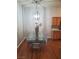 Dining room features glass table, modern chandelier, and hardwood floors at 700 Carnegie St # 2013, Henderson, NV 89052