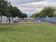 Green community dog park with trees, play structures, and secure fencing at 700 Carnegie St # 2013, Henderson, NV 89052