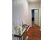 Hallway featuring laminate flooring, a mirrored console table, and fresh white paint at 700 Carnegie St # 2013, Henderson, NV 89052