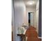 Hallway featuring laminate flooring, a mirrored console table, and fresh white paint at 700 Carnegie St # 2013, Henderson, NV 89052