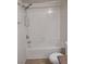 Bathroom with a white tiled shower-tub and toilet at 7255 W Sunset Rd # 2093, Las Vegas, NV 89113