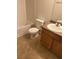 Cozy bathroom featuring a tub, toilet, and vanity with warm wood cabinetry at 7255 W Sunset Rd # 2093, Las Vegas, NV 89113