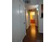 Inviting hallway with wood floors leads to a well-lit bathroom at 7255 W Sunset Rd # 2093, Las Vegas, NV 89113