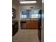 Efficient kitchen with stainless steel dishwasher and wooden cabinets at 7255 W Sunset Rd # 2093, Las Vegas, NV 89113