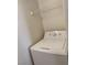 The laundry area has a modern white washing machine and overhead shelving at 7255 W Sunset Rd # 2093, Las Vegas, NV 89113