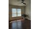 Living room featuring dark wood floors, a ceiling fan, bright windows and neutral paint at 7255 W Sunset Rd # 2093, Las Vegas, NV 89113