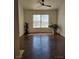 Spacious living room with dark floors, bright windows, a ceiling fan, and neutral paint at 7255 W Sunset Rd # 2093, Las Vegas, NV 89113