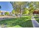 Community playground with climbing area, slide, and bench seating surrounded by green space at 7255 W Sunset Rd # 2093, Las Vegas, NV 89113
