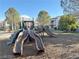 Community playground featuring slides, climbing structures, and shade trees at 7255 W Sunset Rd # 2093, Las Vegas, NV 89113