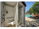 Inviting pool shower stall near a community pool surrounded by greenery at 7255 W Sunset Rd # 2093, Las Vegas, NV 89113