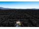Aerial view of a suburban neighborhood, highlighting the house, surrounding landscape, and mountain views at 7624 Molfetta St, Las Vegas, NV 89149