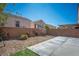 Spacious backyard featuring a stone landscape, ample privacy, and a covered patio at 7624 Molfetta St, Las Vegas, NV 89149