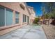 Open backyard with a large patio, stone landscape, and partial view of the house at 7624 Molfetta St, Las Vegas, NV 89149
