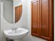 Charming powder room featuring a pedestal sink, updated fixtures, and ample storage at 7624 Molfetta St, Las Vegas, NV 89149