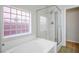Bright bathroom featuring a glass-enclosed shower and a unique window at 7624 Molfetta St, Las Vegas, NV 89149