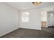 Carpeted bedroom with light walls, an arched window, and chandelier style lighting at 7624 Molfetta St, Las Vegas, NV 89149