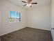 Cozy bedroom with carpet, ceiling fan, natural light, and neutral paint at 7624 Molfetta St, Las Vegas, NV 89149
