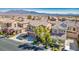 Aerial view of the suburban house featuring a tile roof, manicured landscaping, and mountain backdrop at 7624 Molfetta St, Las Vegas, NV 89149