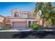 Charming two-story home features a two-car garage, tiled roof, and landscaped front yard at 7624 Molfetta St, Las Vegas, NV 89149