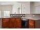 Well-lit kitchen featuring wood cabinets, a black sink, and modern appliances at 7624 Molfetta St, Las Vegas, NV 89149