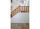 Open staircase with wood banister and plush carpeting provides access to upstairs living at 7624 Molfetta St, Las Vegas, NV 89149