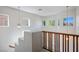 Bright stairway landing with natural light, wooden banister, and view of the surrounding area at 7624 Molfetta St, Las Vegas, NV 89149