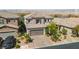 Aerial view of a two-story home featuring a tile roof, desert landscaping, and brick driveway at 7837 Hamilton Pool Dr, Las Vegas, NV 89113