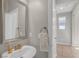 Cozy bathroom with pedestal sink, gold hardware, and a neutral-toned color scheme at 7837 Hamilton Pool Dr, Las Vegas, NV 89113