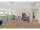 Open bonus room area, perfect for entertaining, with staircase and a media center at 7837 Hamilton Pool Dr, Las Vegas, NV 89113