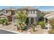 Charming two-story home featuring a tile roof, desert landscaping, and a welcoming covered entryway at 7837 Hamilton Pool Dr, Las Vegas, NV 89113