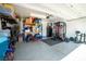 A spacious garage with organized storage shelves, work-out gear, and epoxy flooring at 7837 Hamilton Pool Dr, Las Vegas, NV 89113