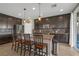 Spacious kitchen featuring dark cabinetry, an island with bar seating, and stainless steel appliances at 7837 Hamilton Pool Dr, Las Vegas, NV 89113