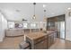 Modern kitchen with large island, granite countertops, and stainless steel appliances at 7837 Hamilton Pool Dr, Las Vegas, NV 89113
