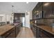 Modern kitchen featuring stainless appliances, an island, and tile backsplash at 7837 Hamilton Pool Dr, Las Vegas, NV 89113