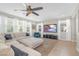 Comfortable living room with sectional sofa, large windows, and neutral tones at 7837 Hamilton Pool Dr, Las Vegas, NV 89113