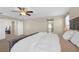 A large main bedroom featuring carpet floors, a ceiling fan, a bed, and an ensuite bathroom at 7837 Hamilton Pool Dr, Las Vegas, NV 89113