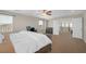 Carpeted main bedroom with a large bed, office area, and an ensuite bathroom at 7837 Hamilton Pool Dr, Las Vegas, NV 89113