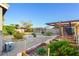 Backyard showcasing desert landscaping, mature trees, a covered patio, and raised garden beds at 7913 Rushmore Ave, Las Vegas, NV 89131