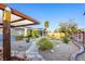 Expansive backyard featuring mature landscaping, a stone walkway and a covered patio, perfect for outdoor entertaining at 7913 Rushmore Ave, Las Vegas, NV 89131