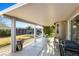 Covered backyard patio offers shade and a relaxing space, complete with a grill and outdoor seating at 7913 Rushmore Ave, Las Vegas, NV 89131