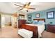 Charming bedroom showcasing a wooden bedframe, complemented by a ceiling fan and tasteful decorations at 7913 Rushmore Ave, Las Vegas, NV 89131