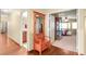 Hallway featuring hardwood floors and charming coatrack with access to bedrooms and bathrooms at 7913 Rushmore Ave, Las Vegas, NV 89131