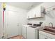 Practical laundry room equipped with modern appliances and storage cabinets for convenience at 7913 Rushmore Ave, Las Vegas, NV 89131