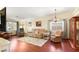 Cozy living room with hardwood floors, comfortable furnishings, and natural light from the windows at 7913 Rushmore Ave, Las Vegas, NV 89131