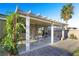 Covered backyard patio with a dining set, lush climbing plants, and a brick paver walkway, ideal for relaxation at 7913 Rushmore Ave, Las Vegas, NV 89131